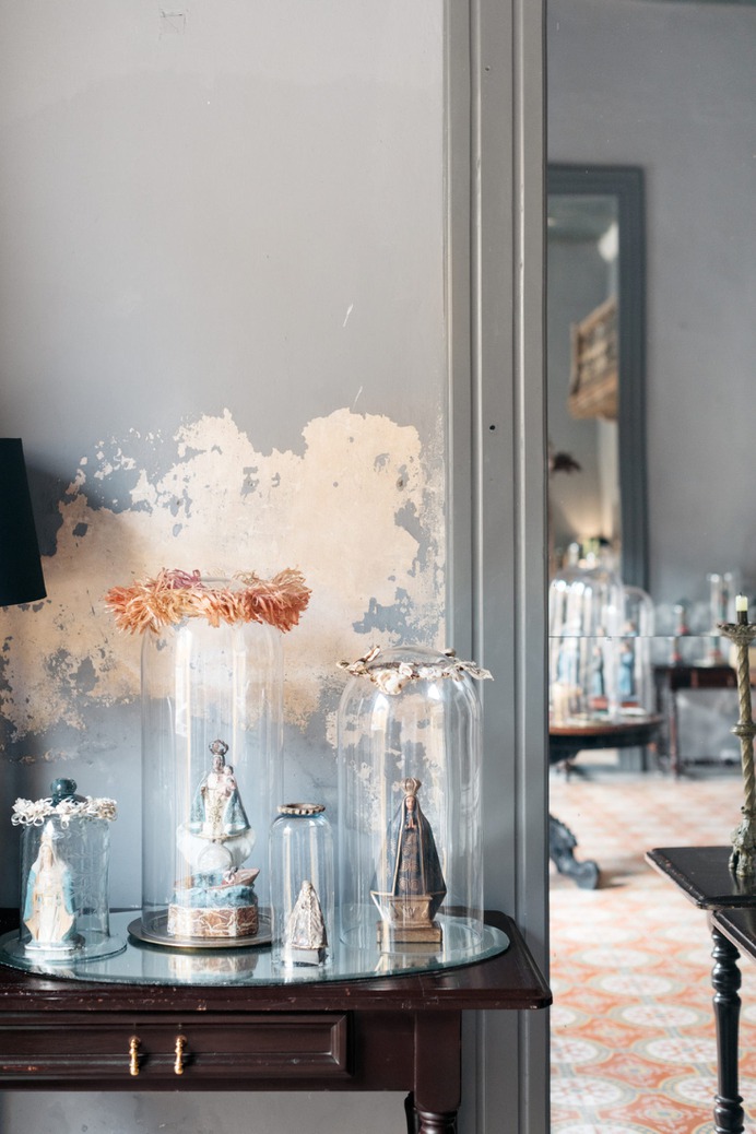 Antique figurines of saints and virgins are enshrined in glass, a nod to the city's famous convent.