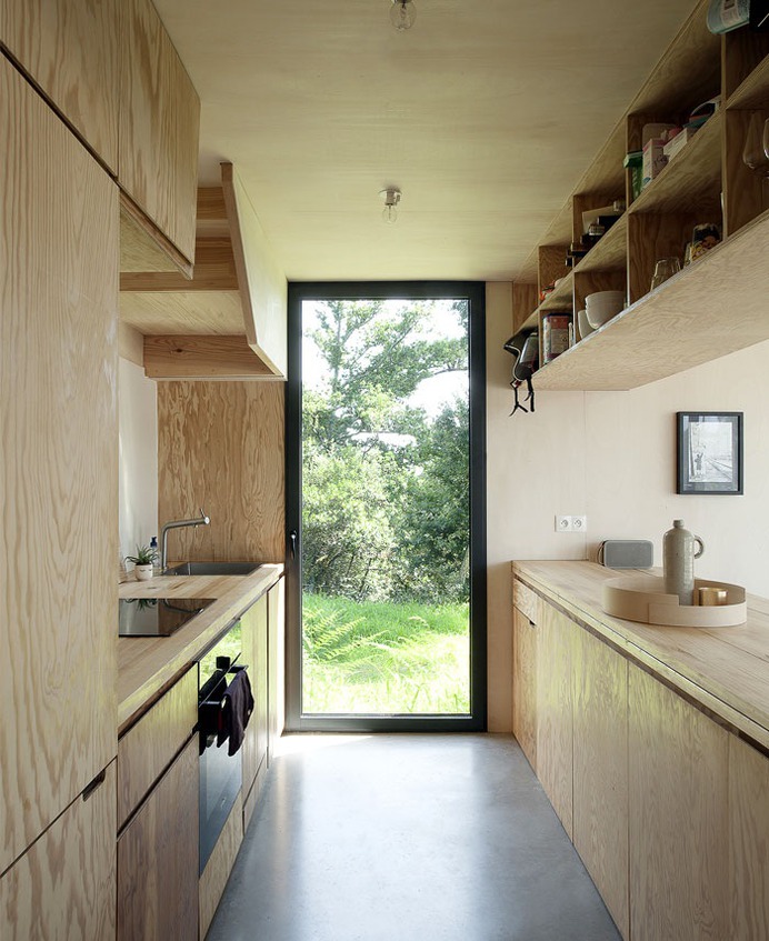 Beach Cottage Covered by a Dark Wood Cladding - InteriorZine