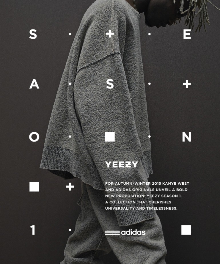 A dark grey campaign visual for Yeezy Season 1 featuring a close-up photograph of a model wearing oversized draped grey knitwear.